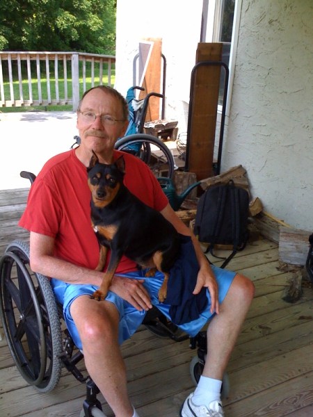 y dad raised me more like a peer, an approach that in retrospect has its pros and cons, but nevertheless has kept us close to this day, and that he has always fed our relationship with inside jokes he responds to with his big cackling laugh. My dad shaped my identity in a lot of ways: the life-defining realization that nerdy and cool are not mutually exclusive, the tacit understanding of the value of holding one's cards close to the chest. He showed me how to be a real listener, cataloguer, and fan of music and obscure knowledge; he can still recite the starting lineup of the 1950 Philadelphia Phillies, and he'll spontaneously sing you a piece of any pop song ever written that might in some way correspond to what you're talking about or doing at the moment, from "Teenager in Love" to "Walking in the Rain" to "Superfreak" to "Hot Child in the City." He is an adroit and frequent user of profanity; he was always the "cool dad" who'd take in my hoodlum friends in high school when they needed a place to crash, but was clearly proud, if a little baffled, that his kid had turned out to be an overachiever. To that end, he argued valiantly in my defense when New York State said I couldn't graduate despite being second in my class because I'd skipped gym class too often, and he won. I love my dad for his ability to essentially to run over adversity of all kinds with his sort of baffling natural likability.   He possesses many virtues to a fault: independent (won't ask for help), generous with money (he's always being taken by amateur cons passing for friends with convincing sob stories), a holder-down of the fort so stalwart he can't stomach change, and a loyal friend to those lucky enough to know him, whether they deserve his friendship or not. My dad doesn't ask anything of me and never has, which has taught me to intuit what it is people need, and what he needs. Which is all the more important since muscular dystrophy put him in a wheelchair in 1994, stripping away any last veil of "normal" he might have been holding up. I love my dad for his response to this fate--essentially a 15 year barrage of self-effacing, uninhibited, rated-R comedy. He takes the concept of the normal paternal role-model--and the "normal" everything else for that matter--turns it sideways, shakes it up, and laughs at it, and for that, I love my dad.